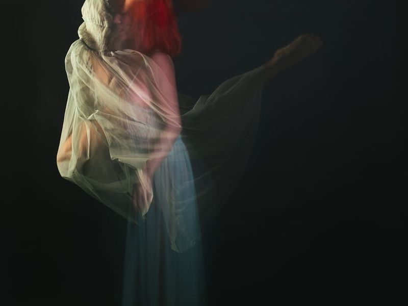 A person in mid-motion during a dynamic stretch, conveying fluidity.