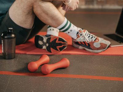 Close-up of athletic shoes on a yoga mat before a workout.